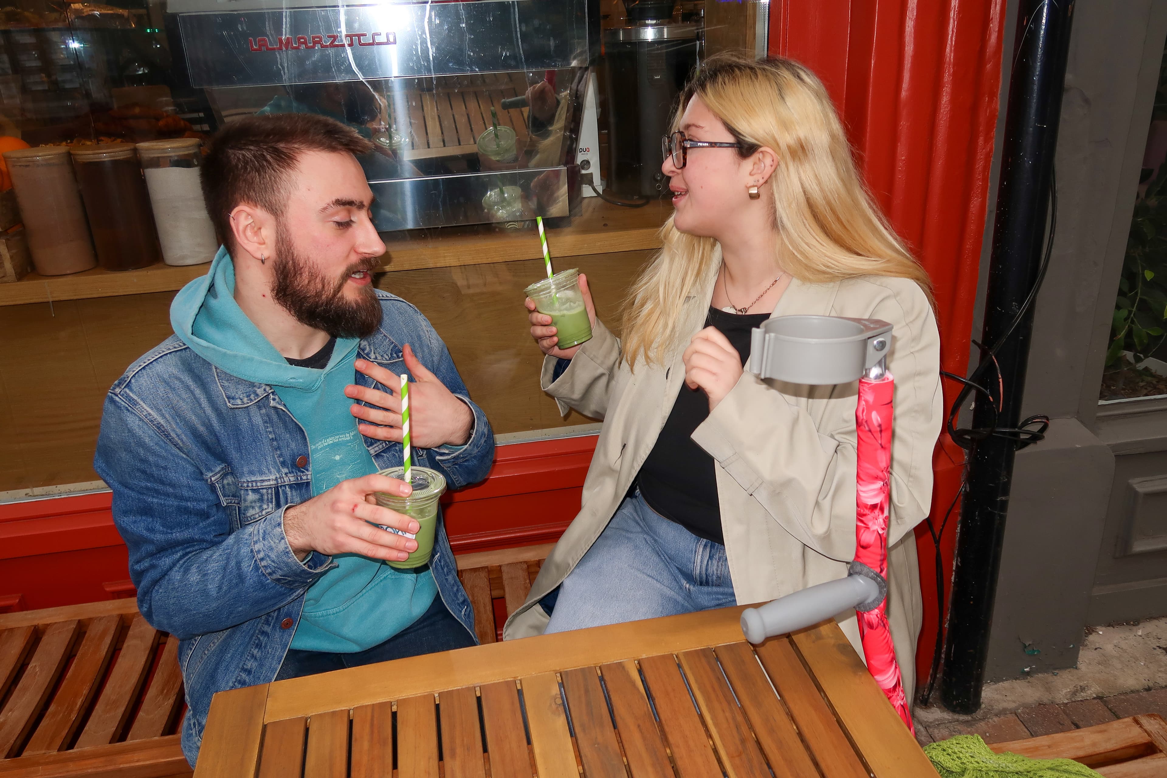Lifestyle — two people at café with Strydr cover visible
