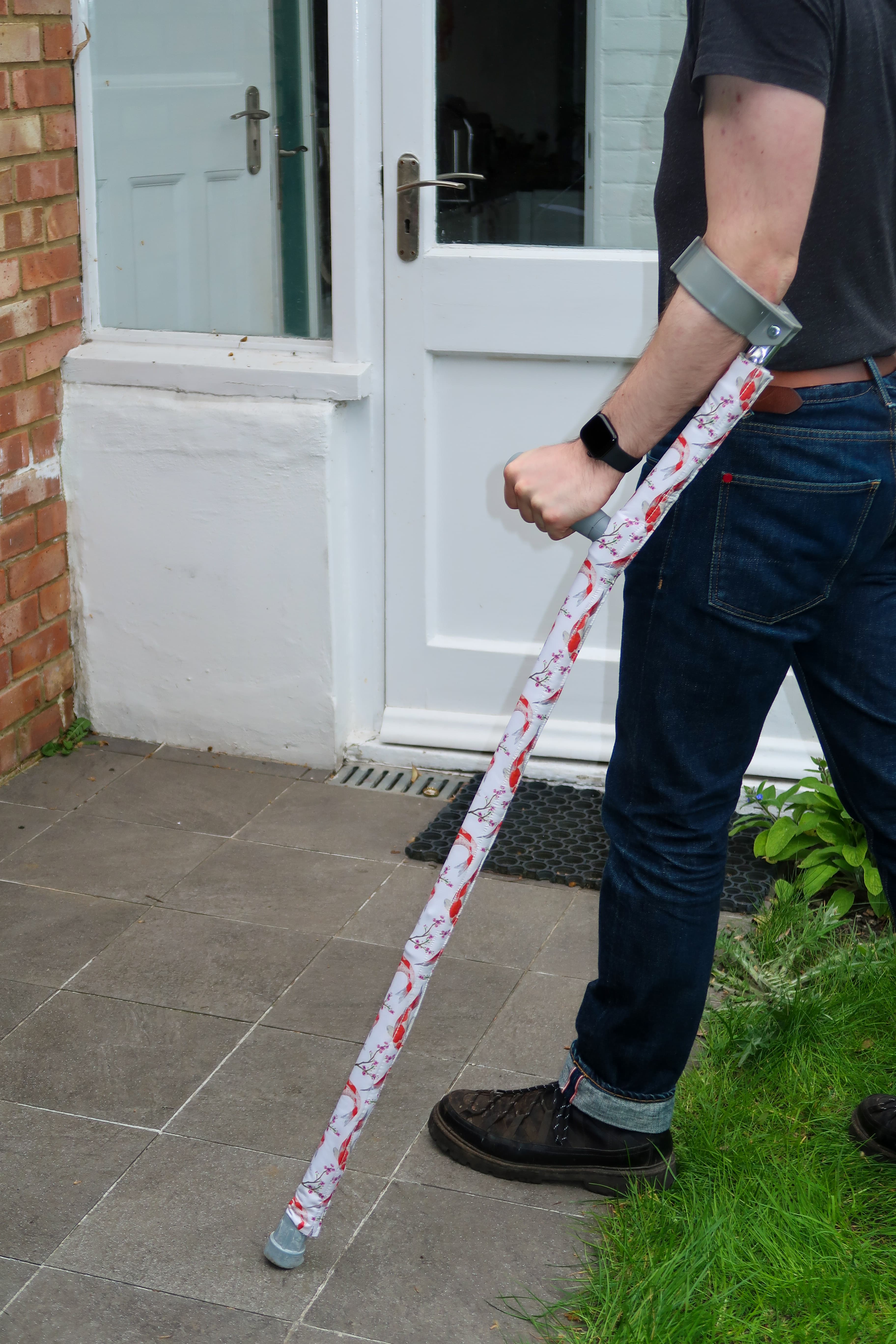Strydr crutch cover detail — floral softshell on doorstep